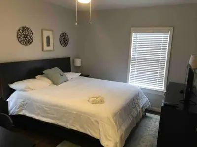 a bedroom with a bed with a teddy bear on it at Stay with Jay Cleveland One in Cleveland