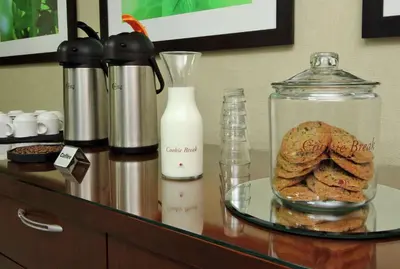 a counter with cookies and a glass jar of milk at Doubletree by Hilton Newark in Newark
