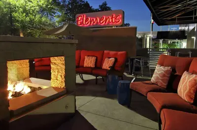 a outdoor patio with couches and a fire place at Doubletree by Hilton Newark in Newark
