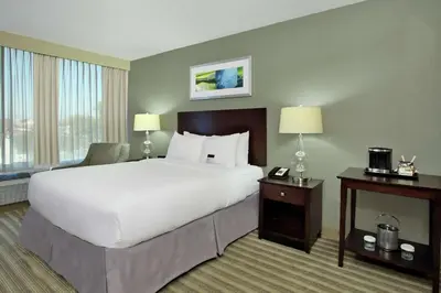 a hotel room with a large bed and a large window at Doubletree by Hilton Newark in Newark
