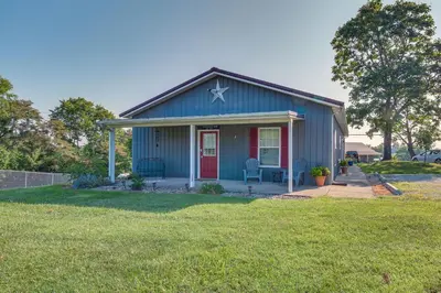 a blue house with a red door on a yard at Kentucky Retreat Near Williamstown Lake! in Williamstown
