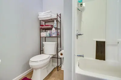 a bathroom with a white toilet and a bath tub at Kentucky Retreat Near Williamstown Lake! in Williamstown