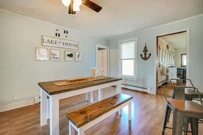 a kitchen with a island in a living room at Downtown Russells Point Cottage Near Indian Lake! in Russells Point