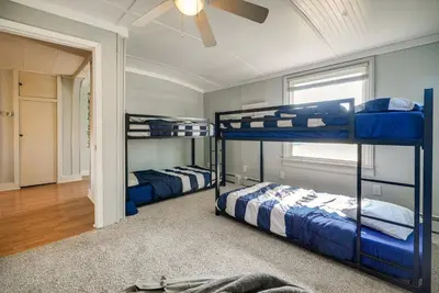 two bunk beds in a room with a ceiling at Downtown Russells Point Cottage Near Indian Lake! in Russells Point