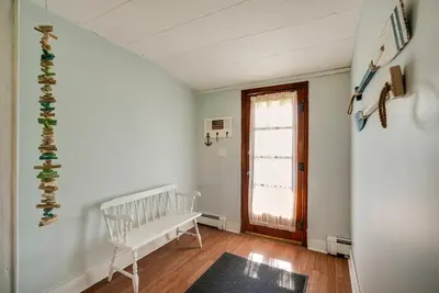 a room with a white bench and a window at Downtown Russells Point Cottage Near Indian Lake! in Russells Point