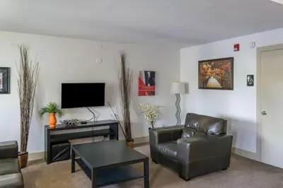 a living room with a couch and a tv at Motel 75 Monroe in Monroe