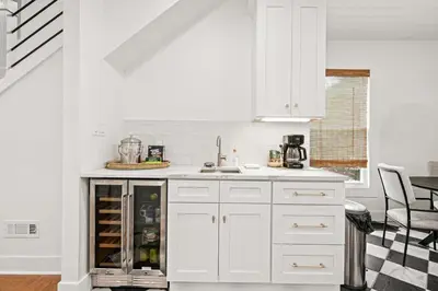 a white kitchen with white cabinets and a sink at 4BR for 10, Near Ark, High-Tech Kitchen, Parking! in Williamstown