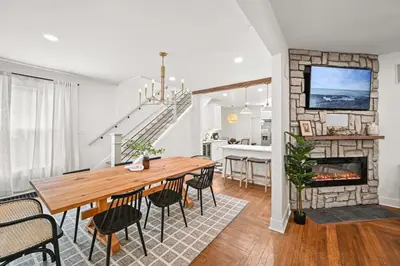 a dining room with a table and a fireplace at 4BR for 10, Near Ark, High-Tech Kitchen, Parking! in Williamstown