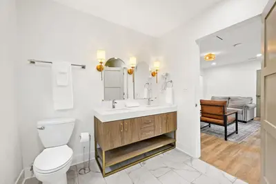 a bathroom with a toilet and a sink with a mirror at 4BR for 10, Near Ark, High-Tech Kitchen, Parking! in Williamstown