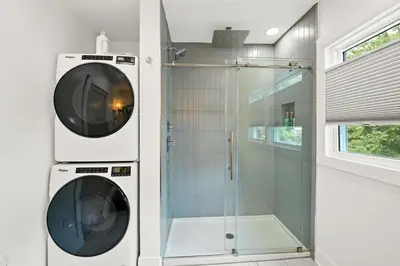 a washing machine and a glass shower in a bathroom at 4BR for 10, Near Ark, High-Tech Kitchen, Parking! in Williamstown