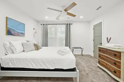 a white bedroom with a bed and a ceiling fan at 4BR for 10, Near Ark, High-Tech Kitchen, Parking! in Williamstown