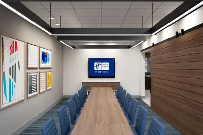 a conference room with a long table and blue chairs at Holiday Inn Express & Suites Lima by IHG in Lima
