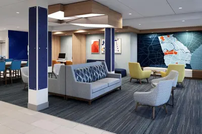 a lobby of a hospital with chairs and tables at Holiday Inn Express & Suites Lima by IHG in Lima