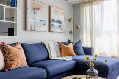 a blue couch in a living room with a table at Exclusive NEW Listing! Maple Heights Charm in Maple Heights