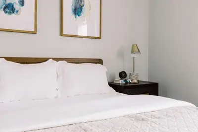 a bedroom with a white bed and a black nightstand at Exclusive NEW Listing! Maple Heights Charm in Maple Heights
