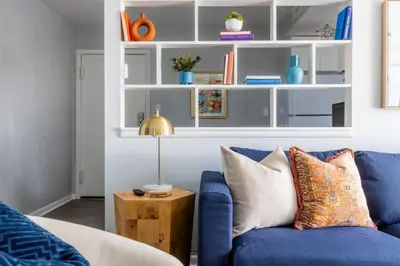 a living room with a blue couch and a table at Exclusive NEW Listing! Maple Heights Charm in Maple Heights