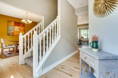 a white staircase in a home with a blue table at Spacious Lewis Center Home with Yard and Gas Grill! in Lewis Center