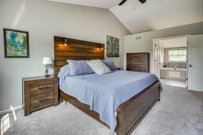 a bedroom with a large bed with a wooden headboard at Spacious Lewis Center Home with Yard and Gas Grill! in Lewis Center