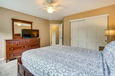 a bedroom with a bed and a dresser and a tv at Spacious Lewis Center Home with Yard and Gas Grill! in Lewis Center