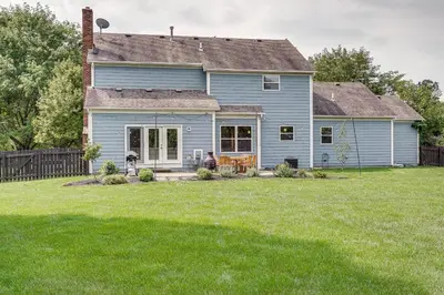 a blue house with a yard with a lawn at Spacious Lewis Center Home with Yard and Gas Grill! in Lewis Center