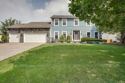 a large blue house with a large yard at Spacious Lewis Center Home with Yard and Gas Grill! in Lewis Center