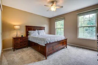 a bedroom with a bed and a ceiling fan at Spacious Lewis Center Home with Yard and Gas Grill! in Lewis Center