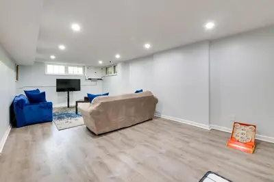 a living room with a couch and a tv at Cleveland Heights Retreat Close to Everything! in Cleveland Heights