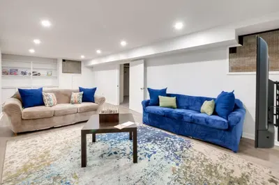 a living room with two blue couches and a table at Cleveland Heights Retreat Close to Everything! in Cleveland Heights