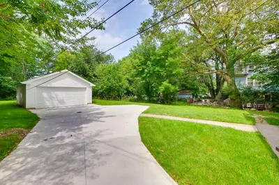a driveway with a garage in a yard at Cleveland Heights Retreat Close to Everything! in Cleveland Heights