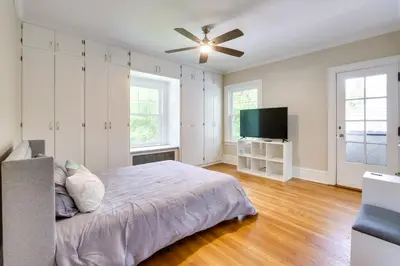 a bedroom with a bed and a flat screen tv at Cleveland Heights Retreat Close to Everything! in Cleveland Heights