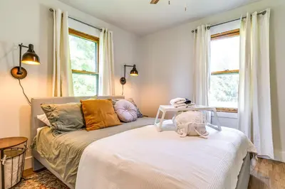 a bedroom with a bed and a couch with windows at 7 Mi to Mounds State Park Indiana Home with Porch! in Daleville