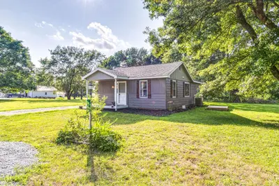 a small house in a field with a yard at 7 Mi to Mounds State Park Indiana Home with Porch! in Daleville