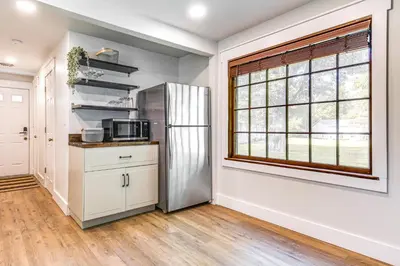 a kitchen with a refrigerator and a window at 7 Mi to Mounds State Park Indiana Home with Porch! in Daleville