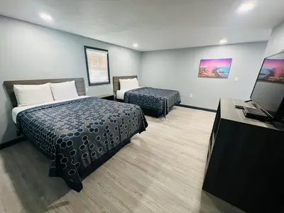 a hotel room with a bed and a television at Hillsboro Inn & Suites in Hillsboro