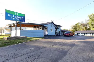 a building with a sign that reads hilleson inn and service at Hillsboro Inn & Suites in Hillsboro