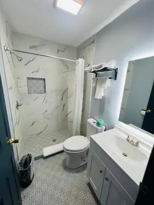 a bathroom with a white toilet and a sink at Hillsboro Inn & Suites in Hillsboro