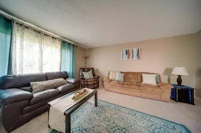 a living room with a couch and a table at Richmond Heights Retreat with Patio and Fire Pit! in Richmond Heights
