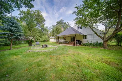 a yard with a house with a picnic table at Richmond Heights Retreat with Patio and Fire Pit! in Richmond Heights