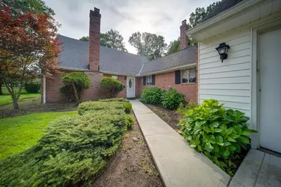 a house with a driveway in front of it at Richmond Heights Retreat with Patio and Fire Pit! in Richmond Heights