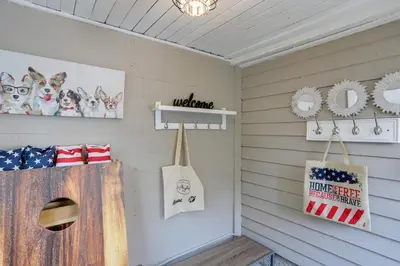 a room with white siding and a wall with an american flag at Welcoming Willoughby Home 1 Mi to Historic Dtwn in Willoughby