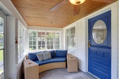 a porch with a blue door and a blue couch at Welcoming Willoughby Home 1 Mi to Historic Dtwn in Willoughby