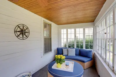 a porch with a blue couch and a table at Welcoming Willoughby Home 1 Mi to Historic Dtwn in Willoughby