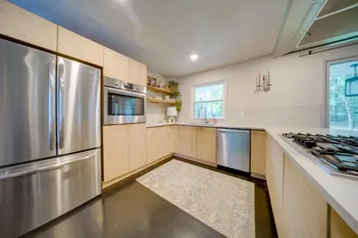 a kitchen with stainless steel appliances and a counter at Stylish Willoughby Hills Retreat with Fireplace! in Willoughby Hills