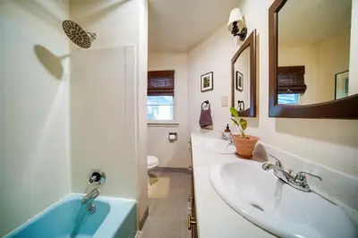 a bathroom with a sink and a mirror at Stylish Willoughby Hills Retreat with Fireplace! in Willoughby Hills
