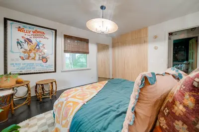 a bedroom with a bed and a movie poster on the wall at Stylish Willoughby Hills Retreat with Fireplace! in Willoughby Hills
