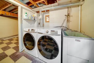 a washing machine and a washer in a room at Stylish Willoughby Hills Retreat with Fireplace! in Willoughby Hills