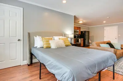 a bedroom with a large bed and a couch at Toledo Vacation Rental about 5 Mi to Downtown! in Toledo