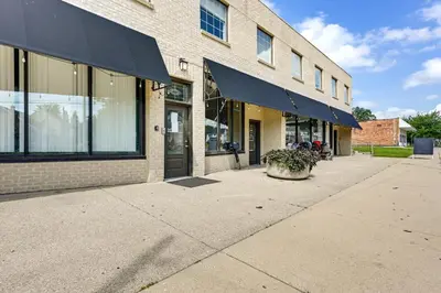 a building with blue awnings on the side of it at Toledo Vacation Rental about 5 Mi to Downtown! in Toledo