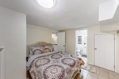 a bedroom with a bed with a patterned bedspread at River Access! Couples Retreat on Working Homestead in Woodburn