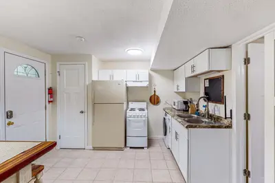 a kitchen with a white refrigerator and a sink at River Access! Couples Retreat on Working Homestead in Woodburn